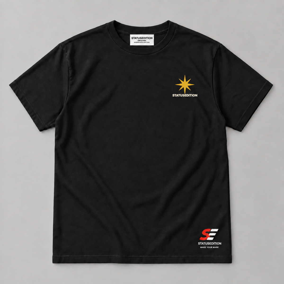 Spark A Kinder World Tee — black front with star chest logo